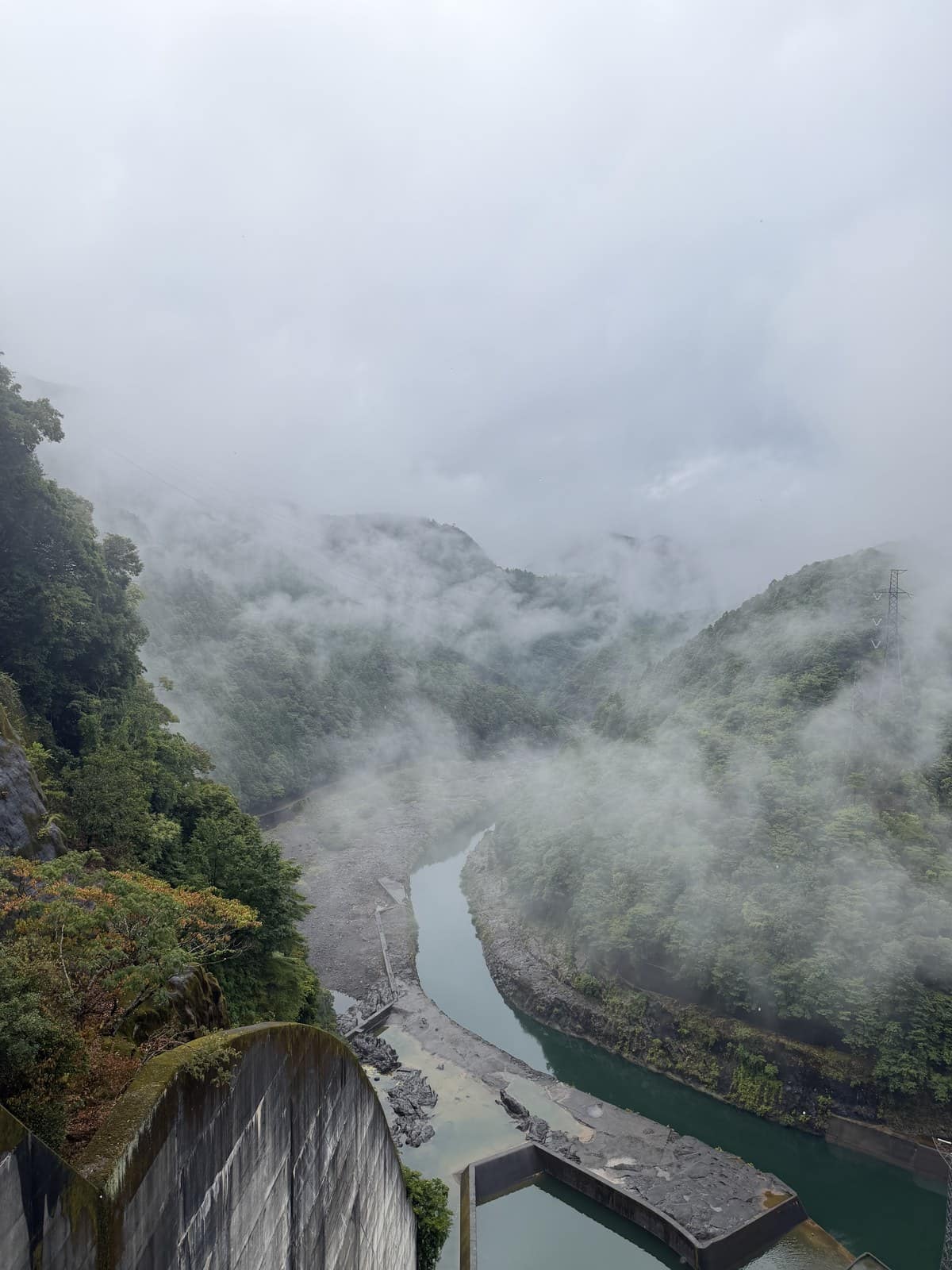 Morning mist rising through the gorge below the arch dam at Lake Ikehara, Nara, Japan