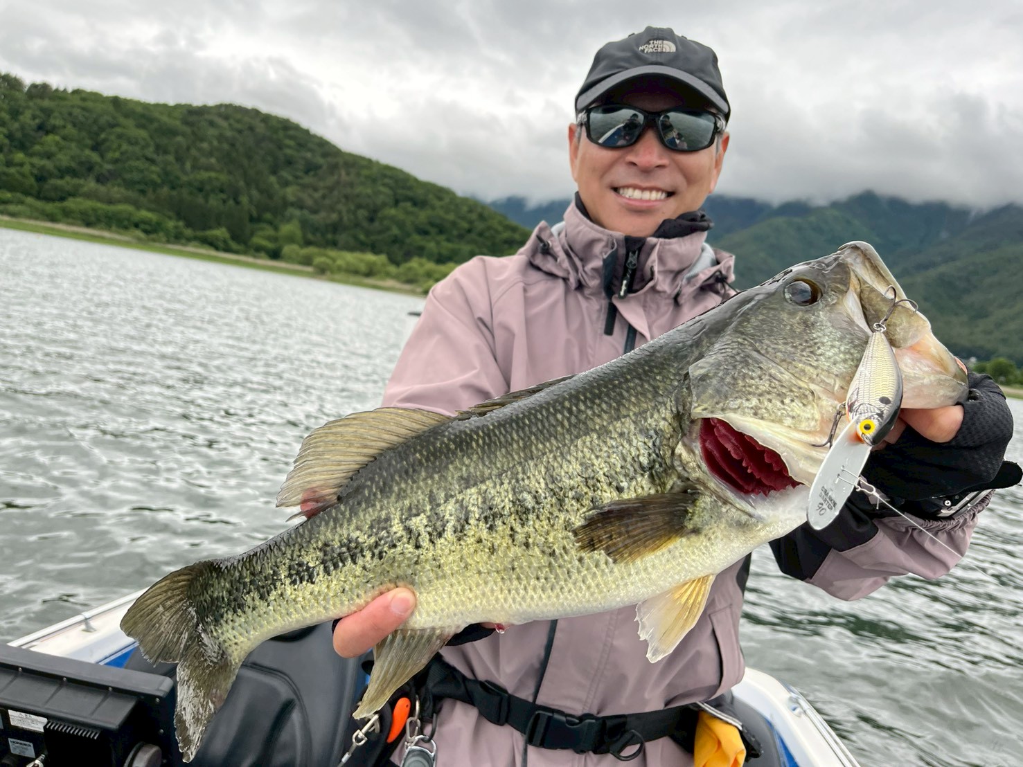 Guest holding a largemouth bass that took a crankbait on Lake Kawaguchi